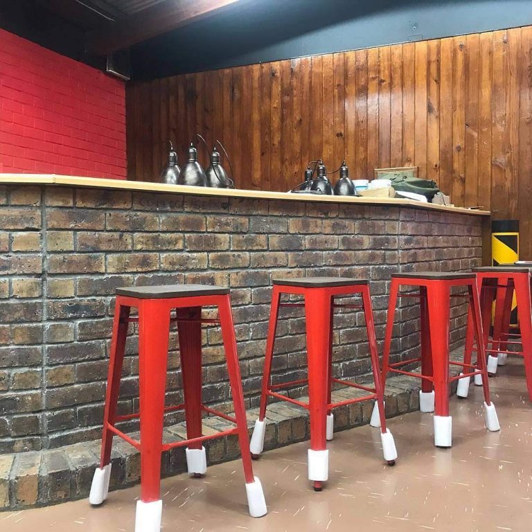 A view of the bar and stools during installation